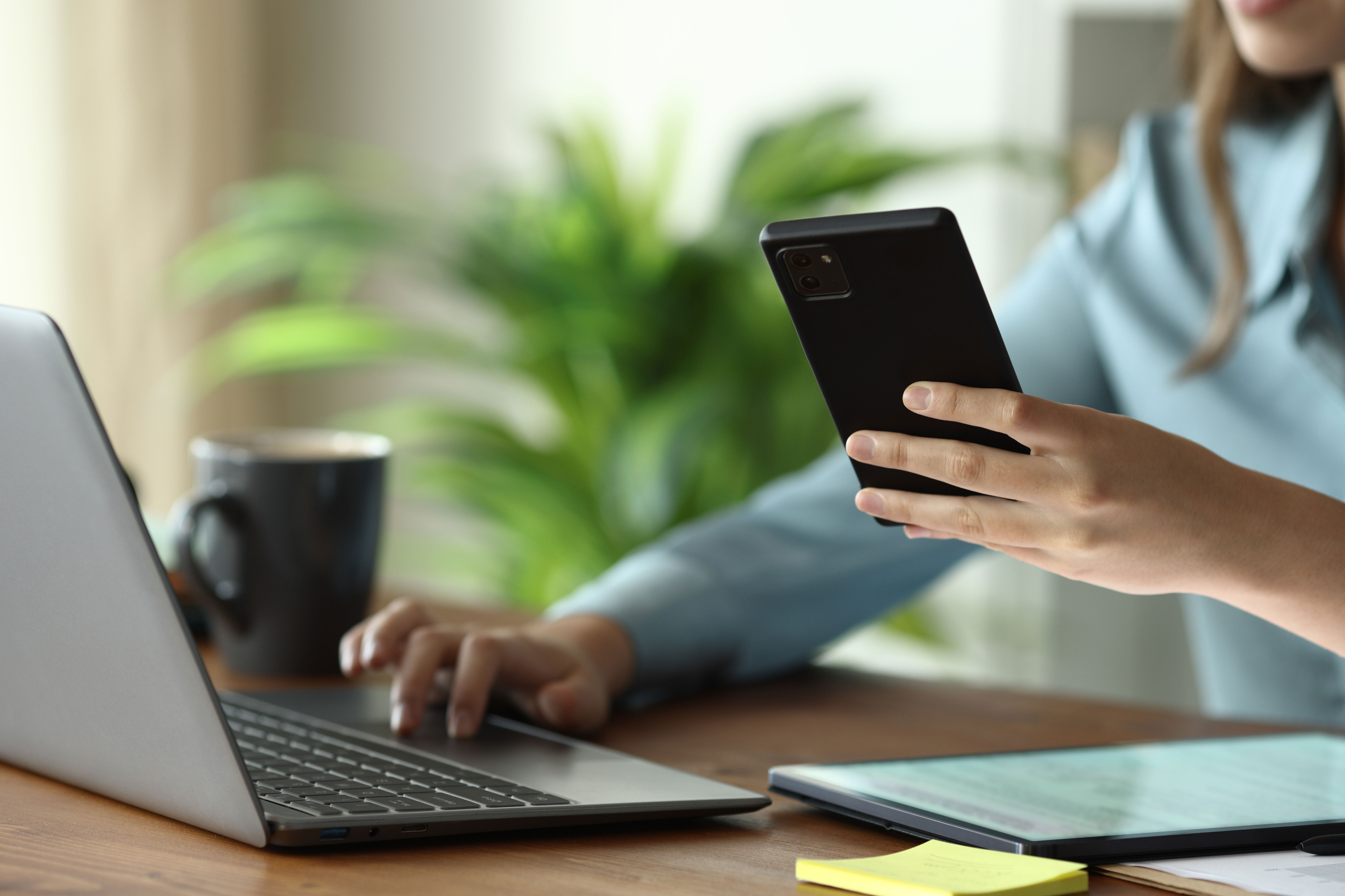 A woman inputting information on a laptop.